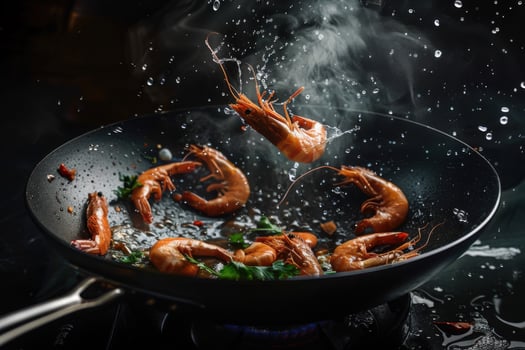 Cooking shrimps in wok, shrimps flying in the air. photo