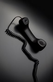 modern telephone receiver on dark back. concept technical support by phone. waiting for an answer. no answer. photo