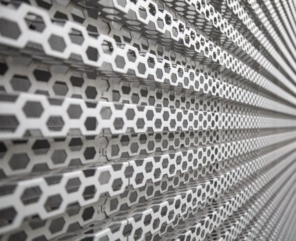 Background of wavy metallic grid with holes. Metal mesh as background. Perforated metal back. photo