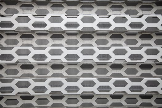 Background of wavy metallic grid with holes. Metal mesh as background. Perforated metal back. photo