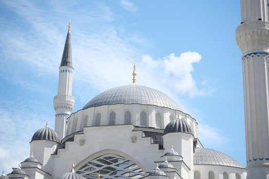 the dome of a mosque against blue sky in istanbul photo