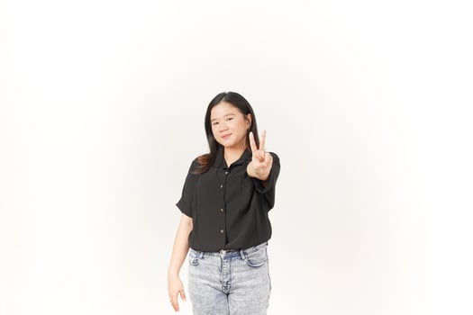 Young Asian woman showing peace sign two finger wearing Black t-shirt and jeans isolated on white background photo