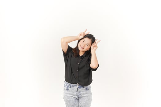 Young Asian woman showing peace sign two finger wearing Black t-shirt and jeans isolated on white background photo