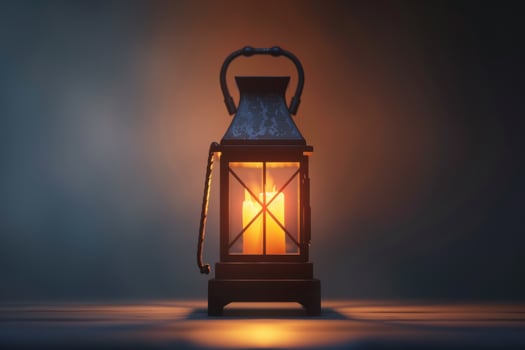 A vintage lantern illuminated on a wooden table set against a dark background in a subtle glow photo