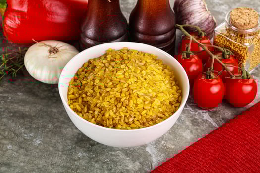 Dry wheat bulgur cereal heap photo