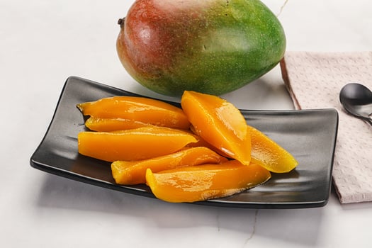 Canned mango slices in the bowl photo