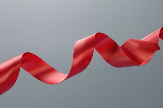Red ribbon swaying gracefully against a neutral backdrop photo
