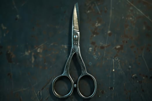 Vintage scissors placed against a rustic dark background, showcasing worn metal and classic design details photo