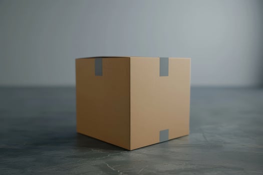 A plain cardboard box sits on a smooth countertop in a well-lit room photo