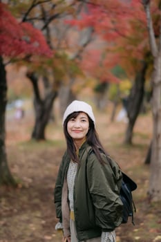 Portrait of a young Asian woman with autumn leaves photo