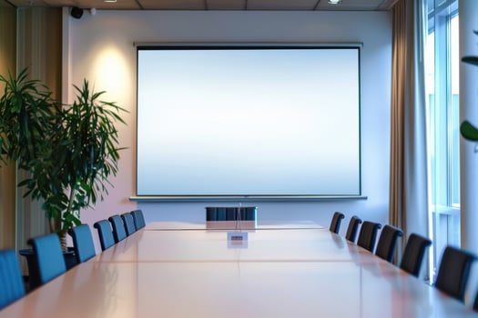 Meeting room with a long table and a large projector screen in a modern office environment photo