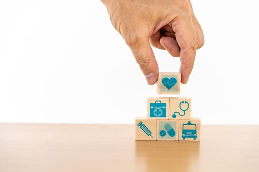 Hand arranging wood block stacking with the medical icon for healthcare and Health insurance management concept photo