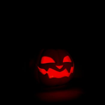 Halloween pumpkin smiles and glowing at night on black background. Scary Jack o lantern,3D rendering photo
