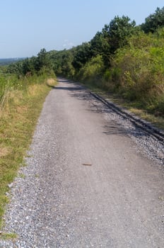 wide gravel path on a hill with a distant view photo