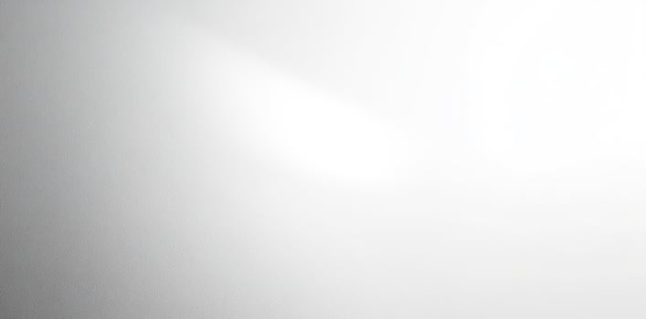 White textured background with a light source at the top right corner photo
