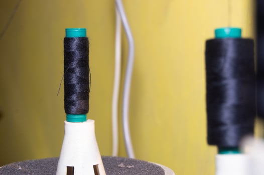 shot on black sewing thread. sewing thread installed in the machine. photo
