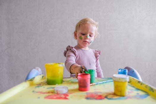 Female toddler drawing at table photo