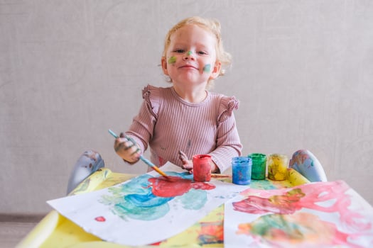 Female toddler drawing at table photo