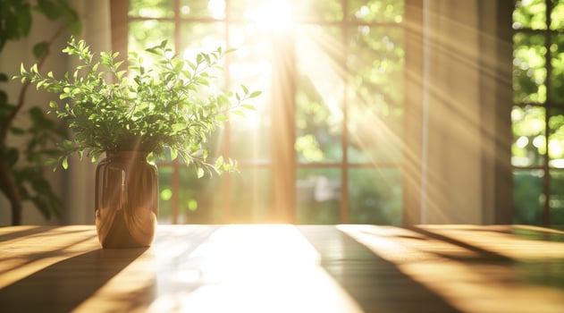 A bright Scandinavianinspired interior features sunlight streaming through large windows, illuminating a stylish vase of fresh greenery on a wooden table, creating a serene atmosphere photo