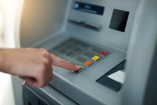 Woman using banking machine photo