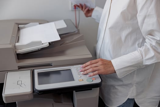 Close up of woman worker scanning a document on photocopy machine In modern office photo