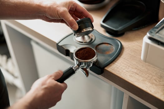 Process of preparing coffee tablet before inserting it into the coffee machine photo