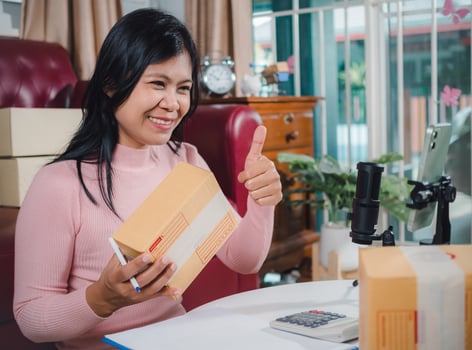 Live to sell products, Owner SME Small review products from camera on her phone, Business online influencer on social media concept, Ecommerce business live streaming vlog new normal concept. photo
