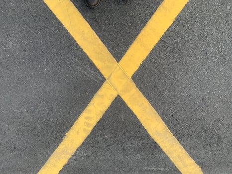 Yellow Crosswalk on Asphalt. A yellow crosswalk painted on a black asphalt road. photo