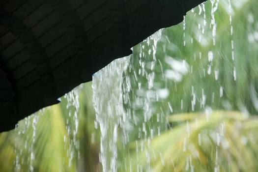 Rainwater falling from the roof during heavy rain during the rainy season in Indonesia photo