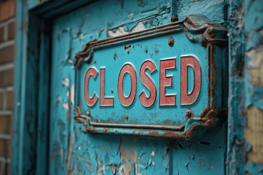 Rusty closed sign hanging on blue rustic door photo