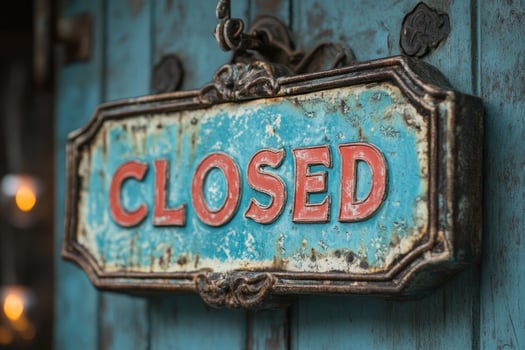 Rusty closed sign hanging on blue rustic door photo