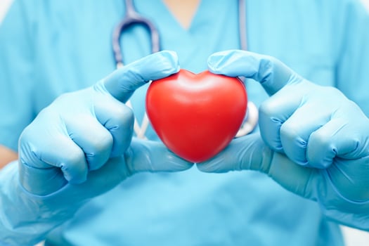 Asian woman doctor holding red heart for health in hospital. photo