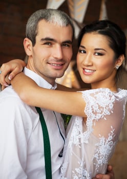 Cheerful married couple standing near the brick wall photo