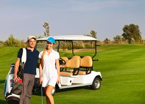 Young sportive couple playing golf on a golf course photo