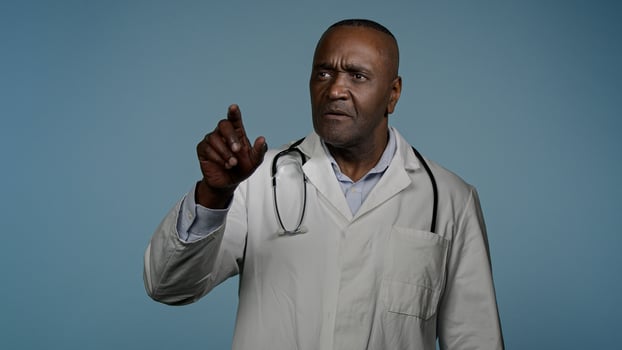 Focused african american man doctor male professional medical worker healthcare employee in blue studio move hands in air imitating work on 3D hologram diagnostics using modern innovative technology photo