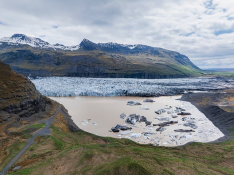 Aerial View of Glacial Lake with Icebergs and Mountains in Iceland photo