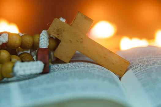 Close up of Holy Rosary on top of a Bible. Christianity and Religious concept photo