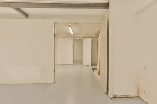 An empty room with a white wall and a door photo