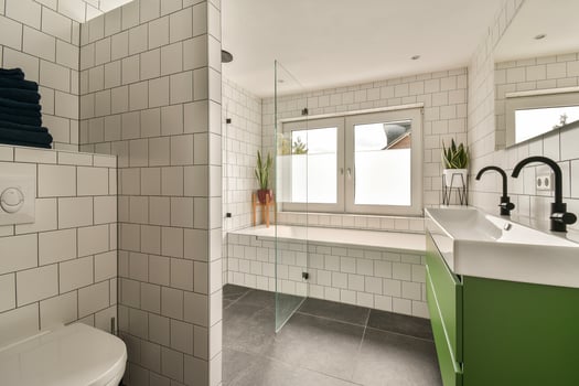 A bathroom with a green and white sink and toilet photo