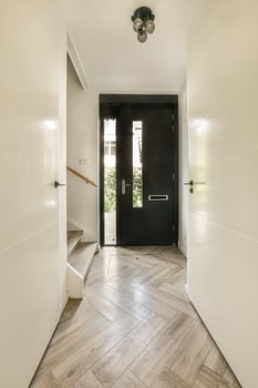 A hallway with white walls and wooden floors photo