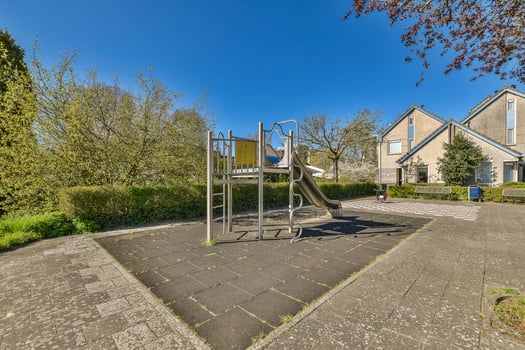 A playground with a slide and a swing photo