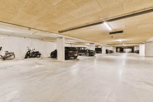 An empty parking garage with motorcycles and cars photo