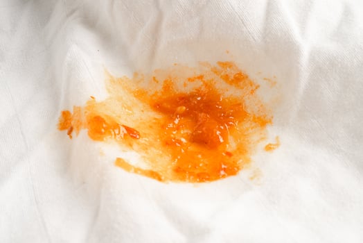 Dirty tomato sauce stain or ketchup on cloth to wash with washing powder, cleaning housework. photo