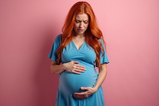 photo of pregnant woman surprise emotion standing on pink background,