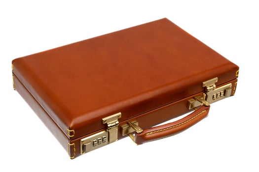 Brown leather suitcase with combination lock and gold locks isolated on white photo