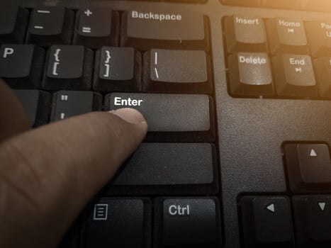 The finger push on the Enter key on the keyboard , Aprove data concept. photo
