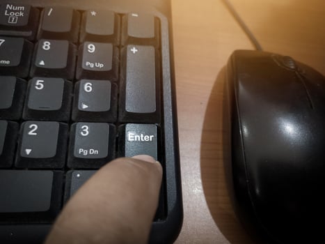 The finger push on the Enter key on the keyboard , Aprove data concept. photo