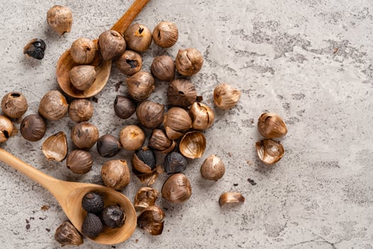 Fermented black garlic. The color is a result of the Maillard reaction or caramelization. Black garlic can help to regulate blood sugar levels photo