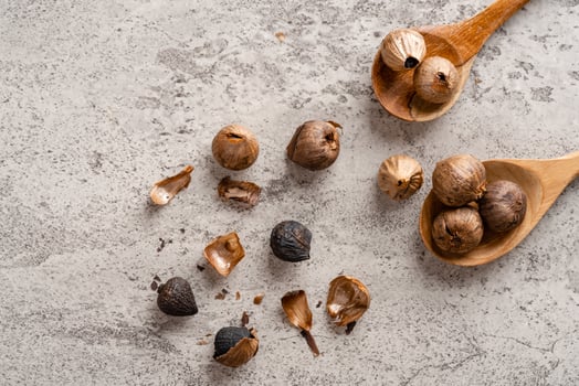 Fermented black garlic. The color is a result of the Maillard reaction or caramelization. Black garlic can help to regulate blood sugar levels photo