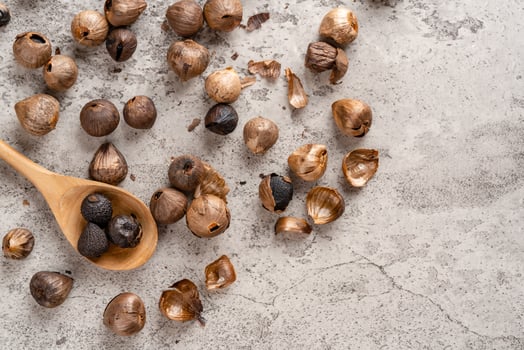 Fermented black garlic. The color is a result of the Maillard reaction or caramelization. Black garlic can help to regulate blood sugar levels photo